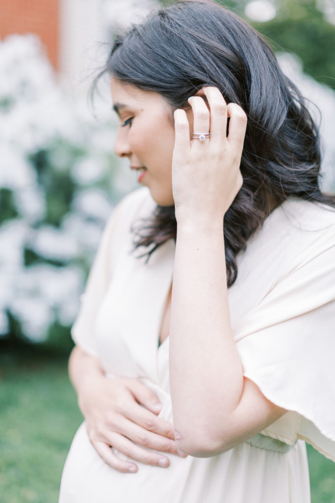 A woman caressing her hair during a VA maternity shoot.
