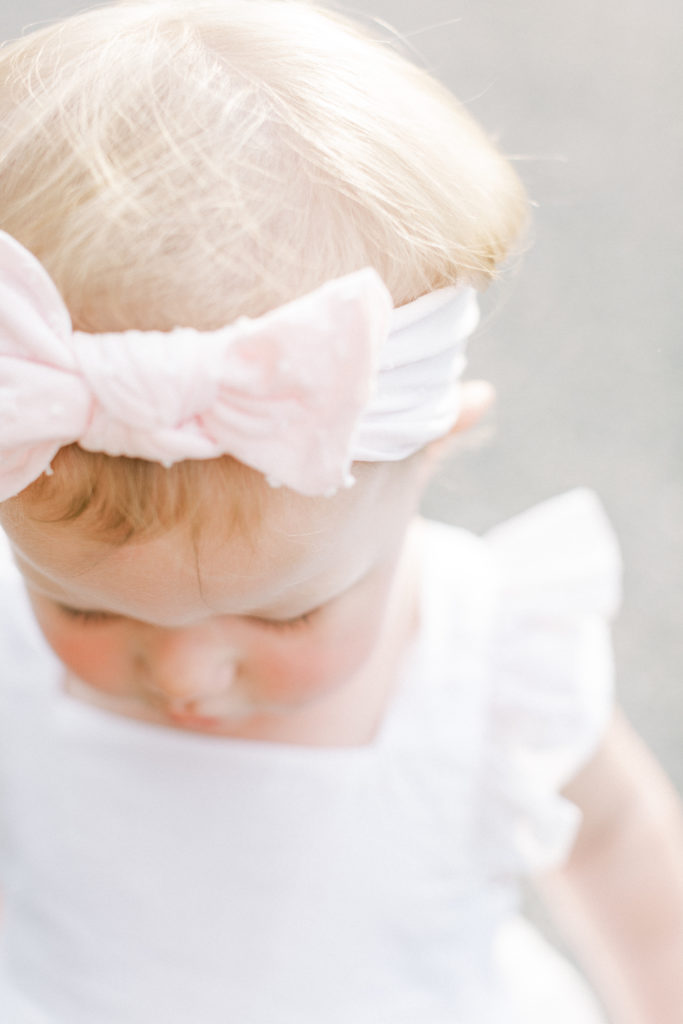 A little girl's head with a pink bow