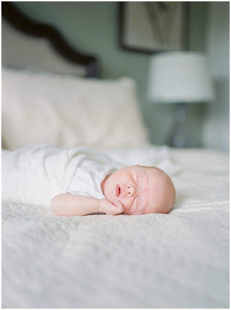 Baby on bed during Bethesda newborn photography session