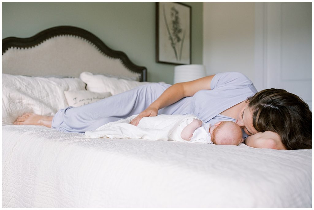 What to Wear for Your Washington DC Newborn Session | New Mother Lays on Bed with Her Newborn