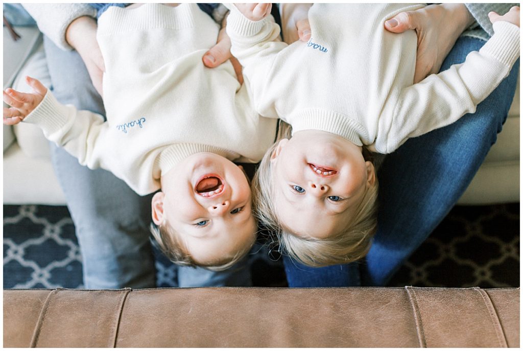 One year old twins hanging upside down/