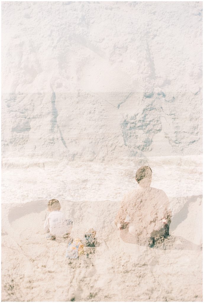 Double exposure of sand and father and son sitting on the beach.