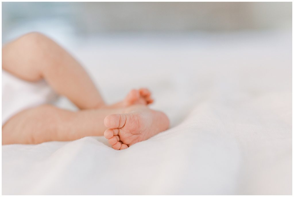 Baby toes on a bed during a DMV newborn session