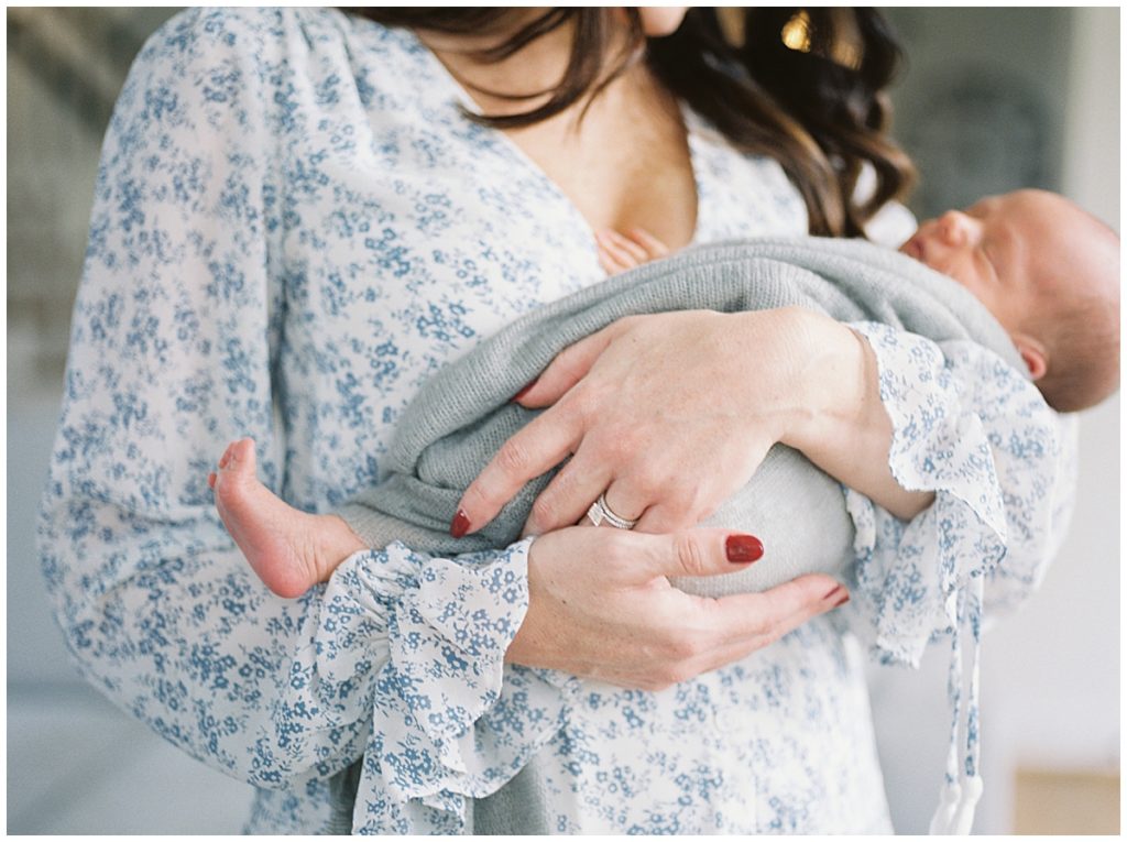 Mother holds infant during Arlington newborn session outside of Washington DC.