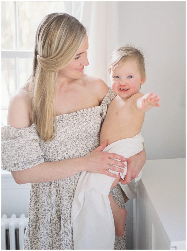 DC Baby Photographers - Mother holds her toddler daughter at home