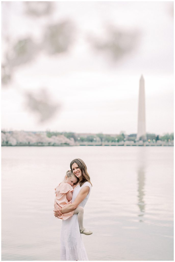 Washington, DC Family Photographer | Mother holding her daughter at the Tidal Basin cherry blossoms
