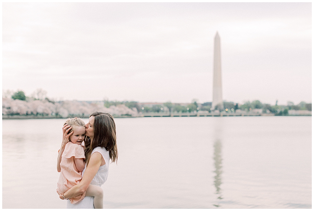 Mother kisses daughter's head during Washington, DC family session