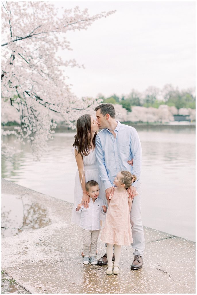 Washington, DC Family Photographer | Family stands along Tidal Basin during cherry blossom season