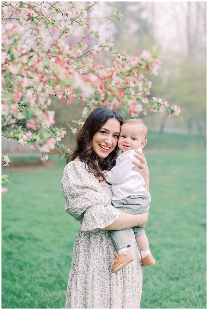 Mother and baby in front of a cherry blossom tree outside of Washington, D.C.