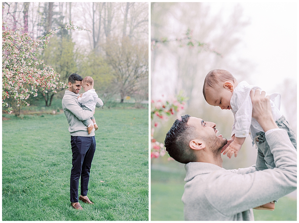 Father holds his son during a family session in a garden.
