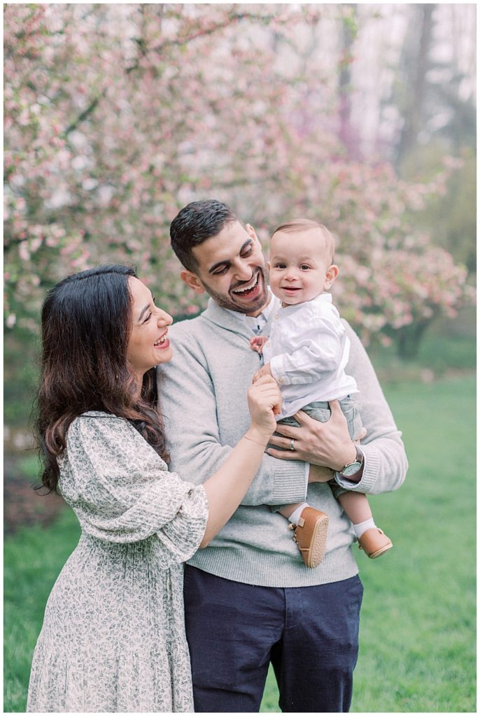 Mother, father, and baby boy in Brookside Gardens photo session with cherry blossom tree.
