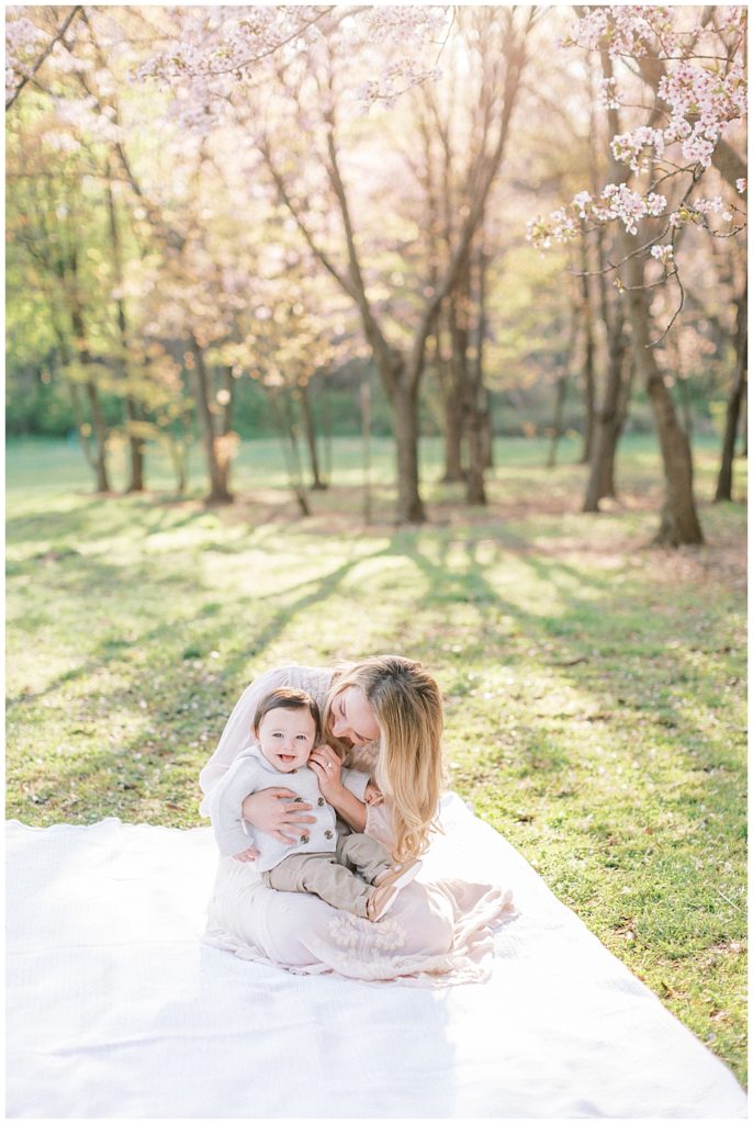 Family Photographer in DC | Mom cuddles with her baby at the National Arboretum cherry blossoms
