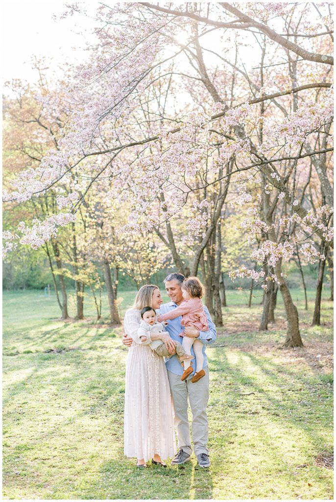 DC Family Photographer | Family stands by the cherry blossom trees at the National Arboretum