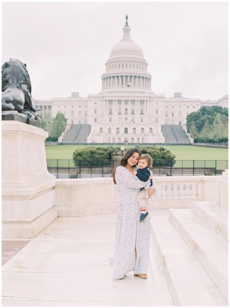 Family photographers in DC | Mother holds her son outside the U.S. Capitol Building during their DC photo session