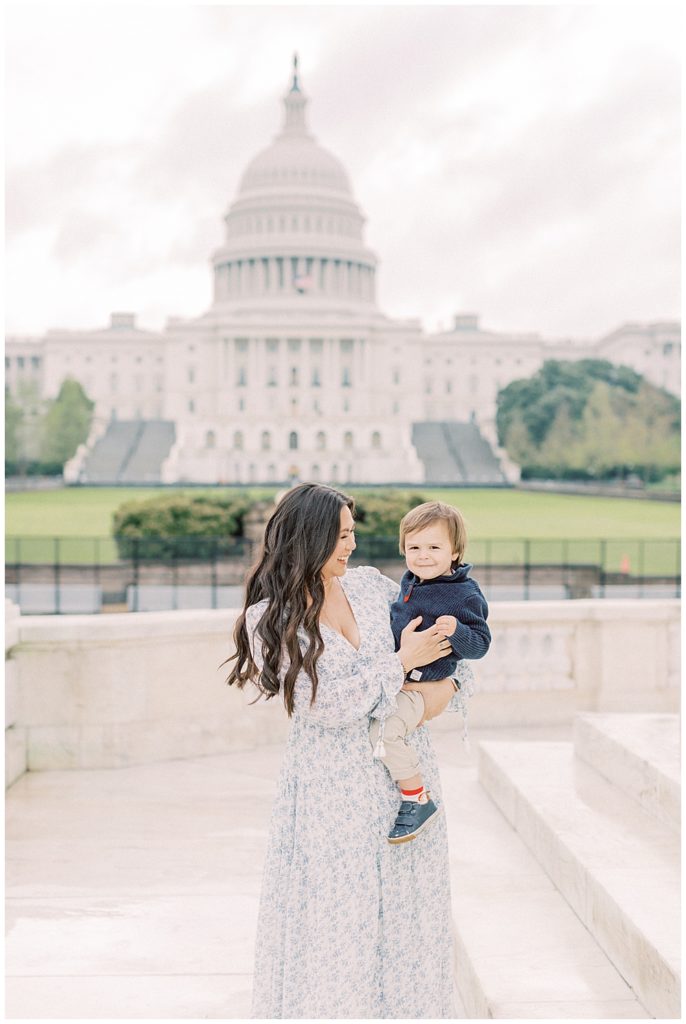 Family Photo Session at the US Capitol, Washington DC | Mother holds her toddler son in front of the U.S. Capitol Building