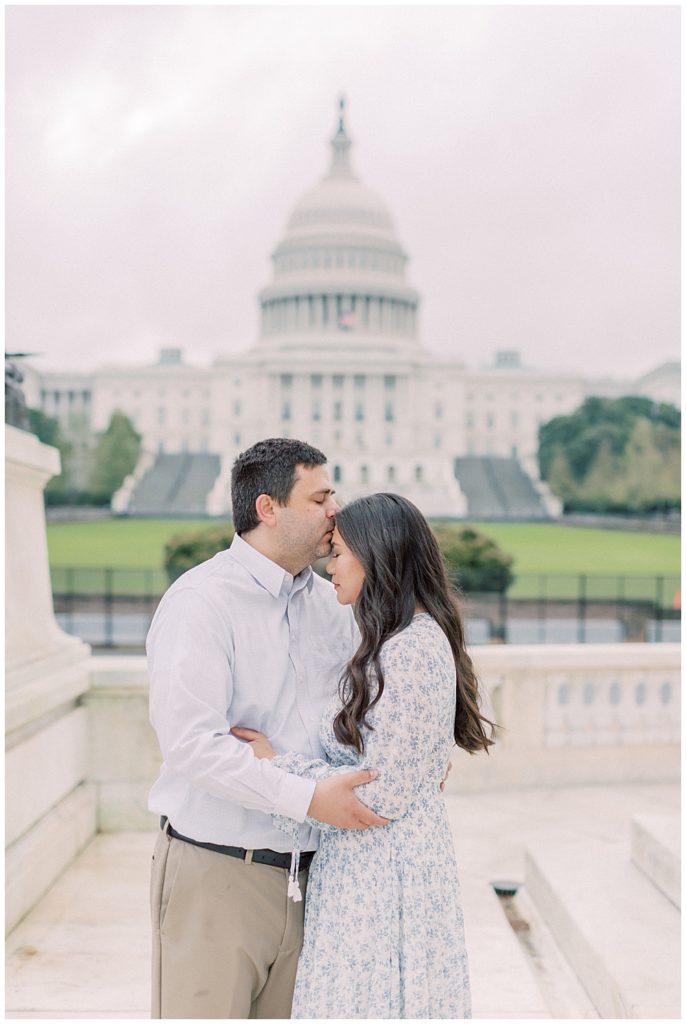 Father kisses his wife's head during their U.S. Capitol family session