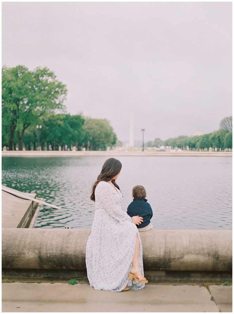 Mom and son look out at the Washington Monument at the Capitol Reflecting Pool