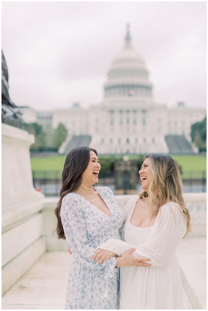 Sisters laugh together outside the US Capitol during their family photo session