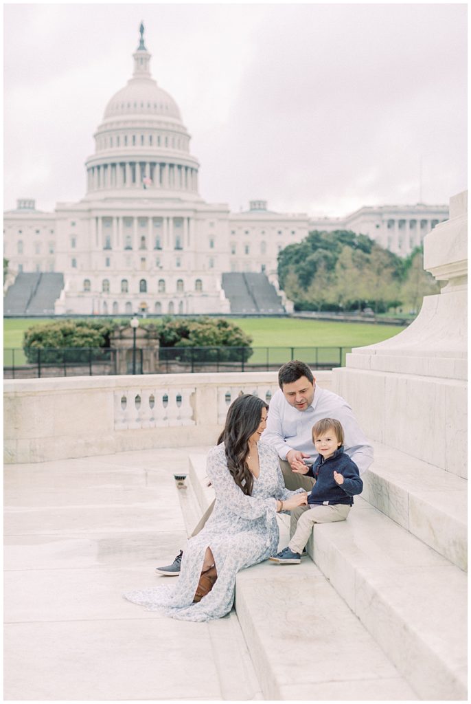 Family plays on the steps of monument outside the U.S. Capitol Building during a family session