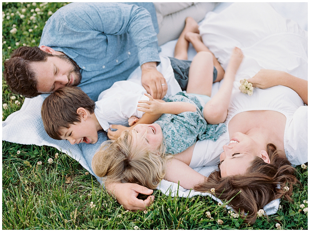 Family photographers in Maryland | Family lays down in field during their family photo session