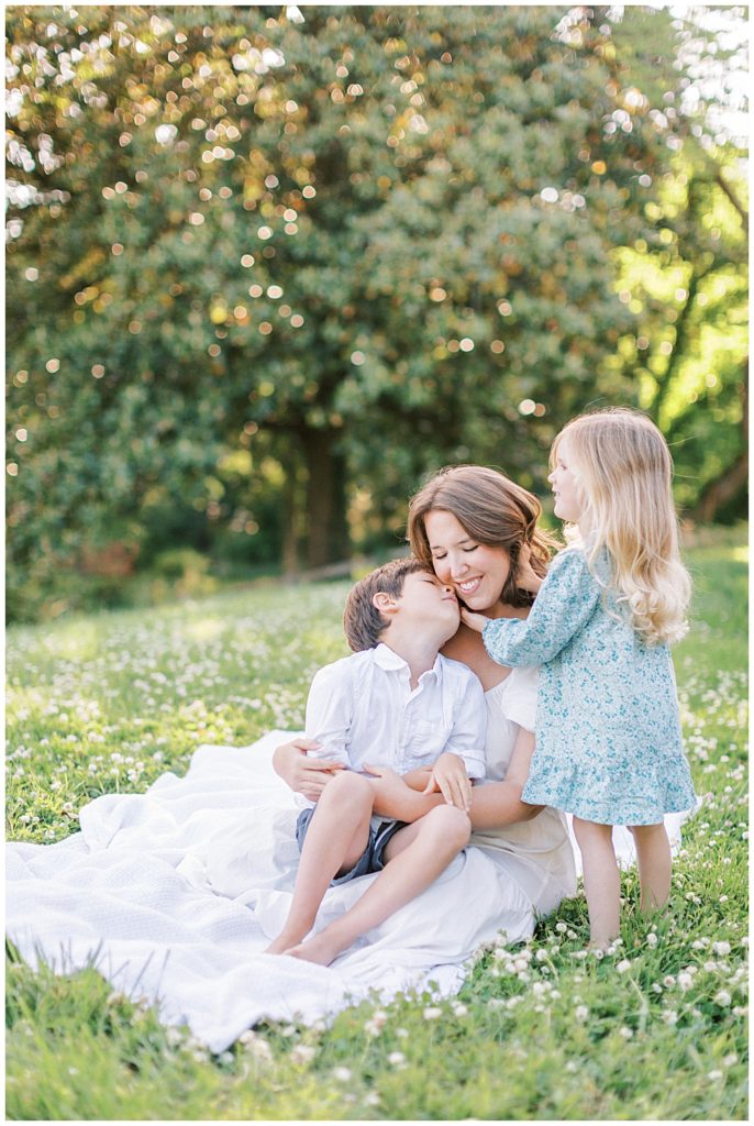 Little boy kisses his mother's cheek during their Maryland family photo session