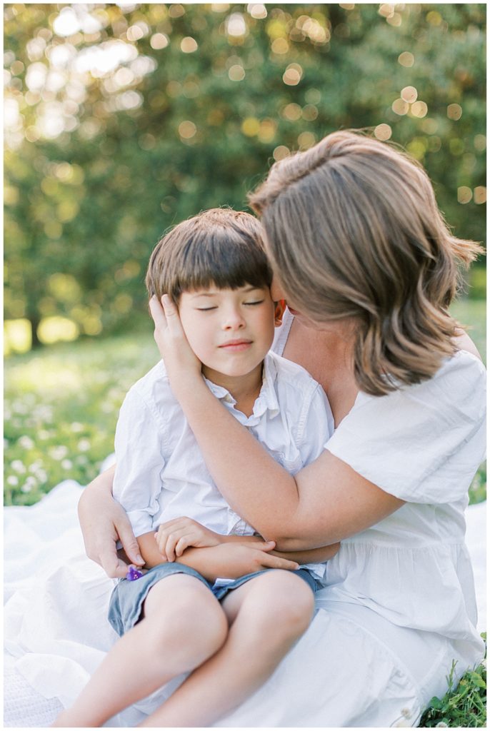  Mother holds her son and caresses his cheek | Family Photographers in Maryland