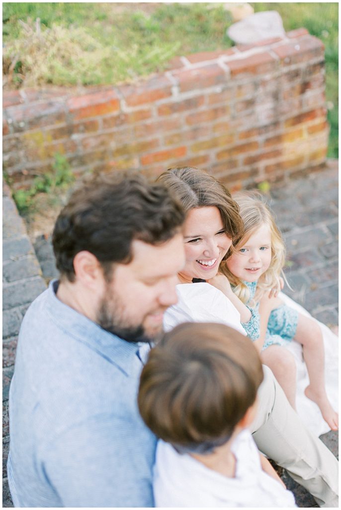 Mother smiles at her family during their Maryland family photo session