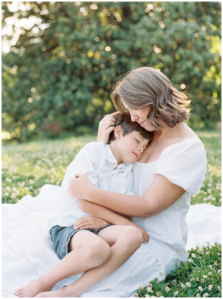 Mother holds her son on her lap at Mulberry Fields in Southern Maryland