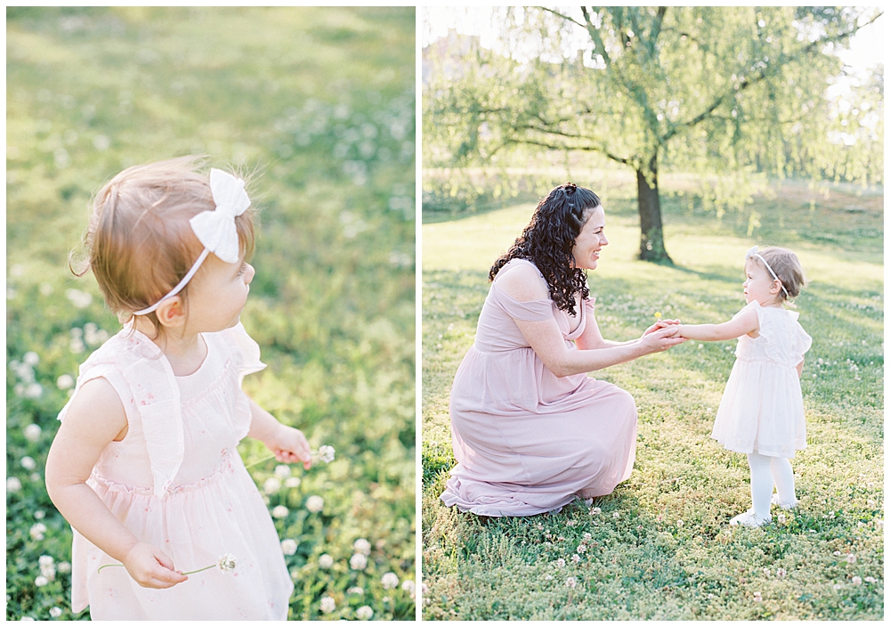 Maryland Maternity Photographers | Mother bends down to take a flower her toddler daughter find for her