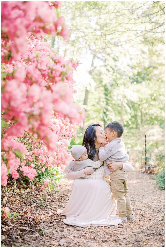 Mother and son kiss next to the pink azaleas at Brookside Gardens