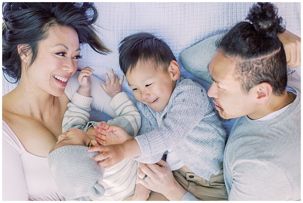 Washington, D.C. Family Photographer | Family laughs together while laying down on a blanket