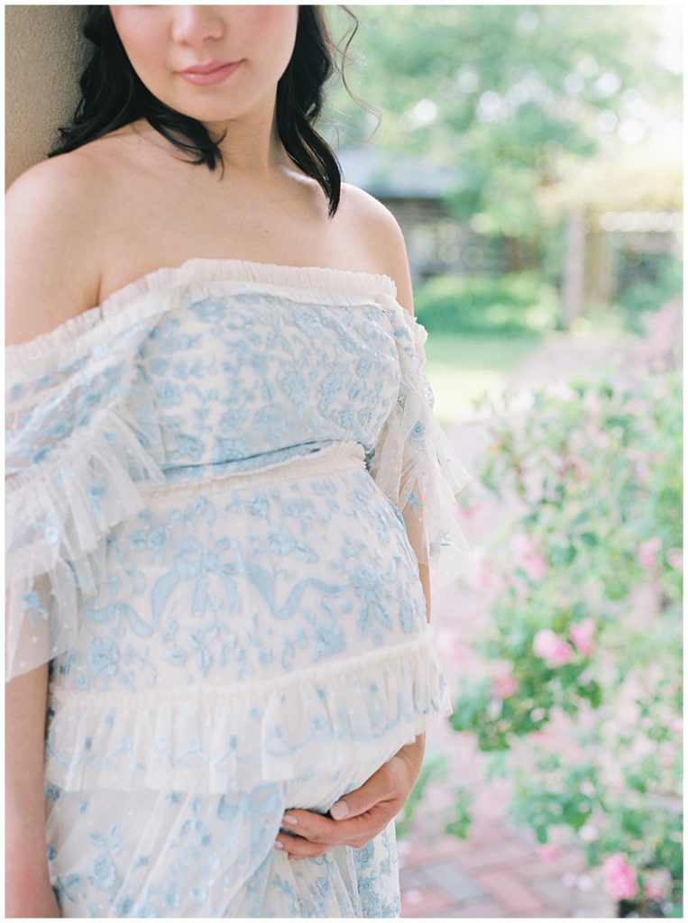 Pregnant woman holds her belly during DC maternity shoot at Tudor Place