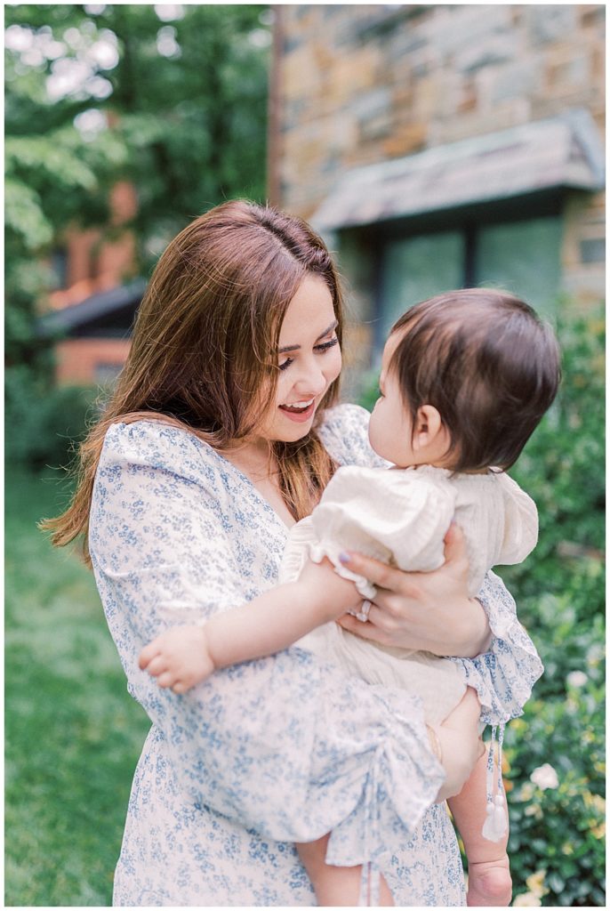 Mother looks lovingly at her one year old during their NOVA family session