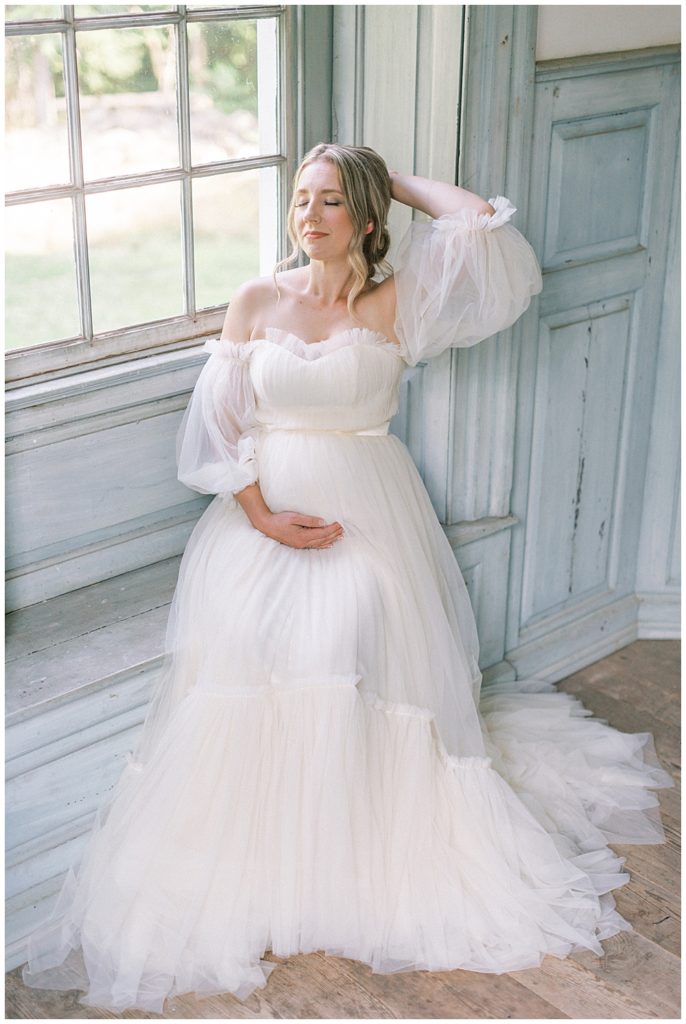 Washington DC Maternity Photographer | Pregnant woman sits in window at Salubria