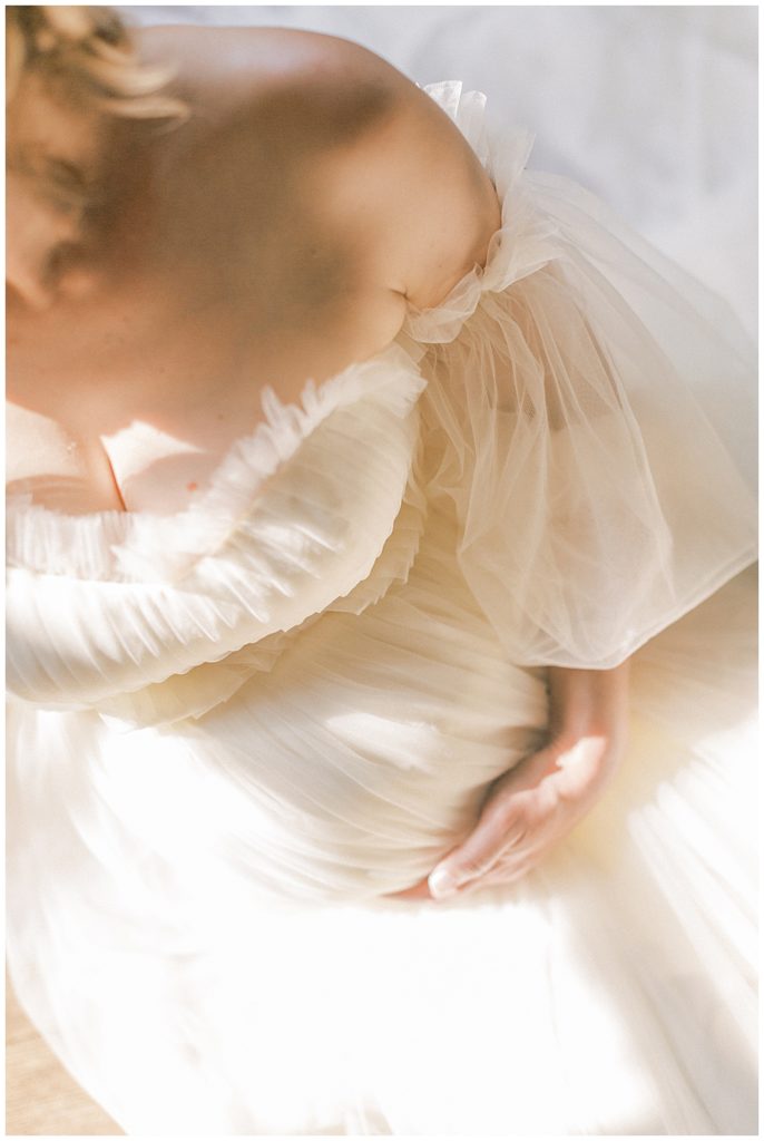 Light hits a woman's pregnant belly during her Salubria maternity session in Northern Virginia