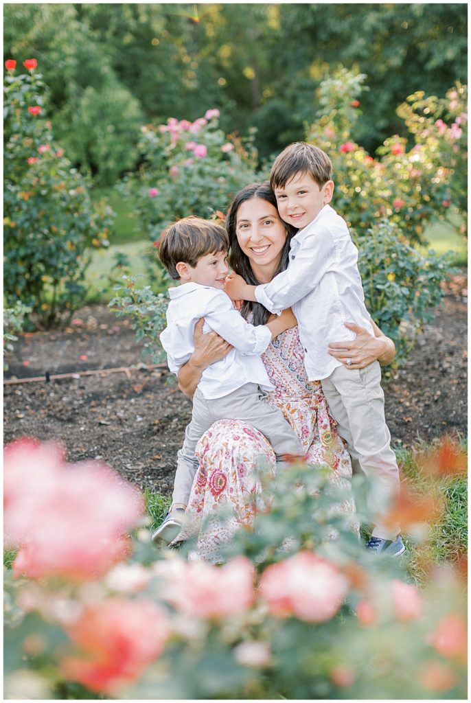 Two young sons hug their mother at the Bon Air Rose Garden in Arlington VA