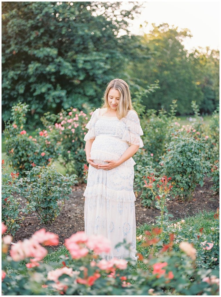 Pregnant mother stands in the Bon Air Rose Garden in Arlington, VA during her maternity session