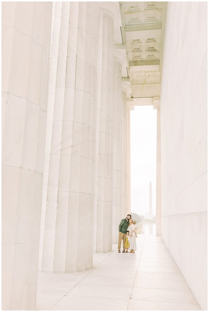 Family stands in the Lincoln Memorial in Washington DC