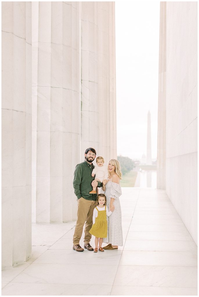 Family stands together at the Lincoln Memorial during their DC family photos