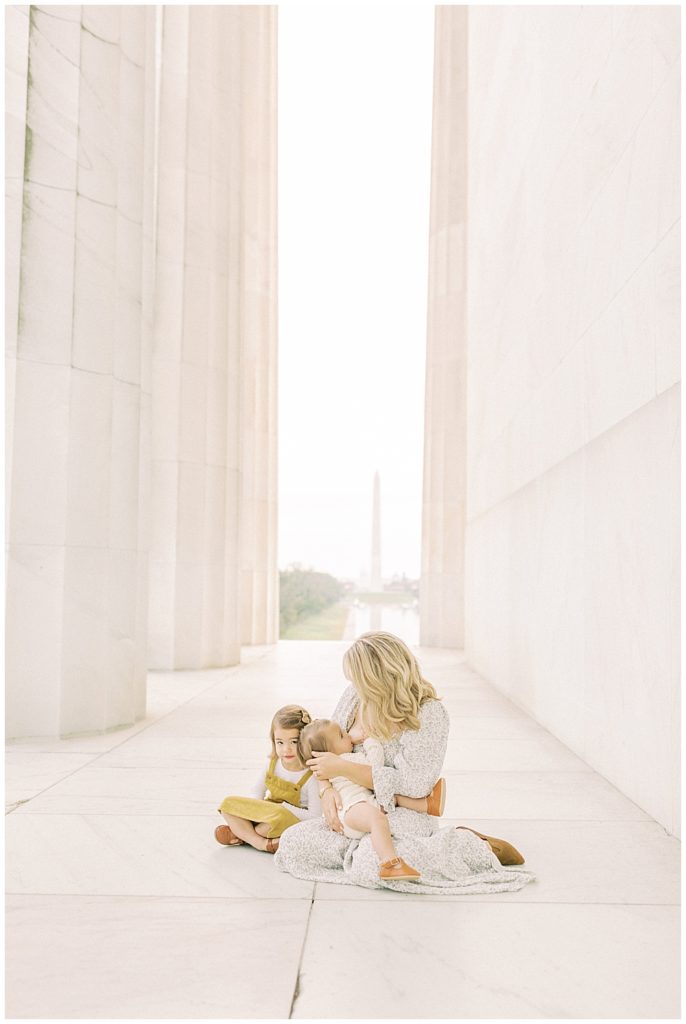 Mother nurses her daughter during the Lincoln Memorial family photo session