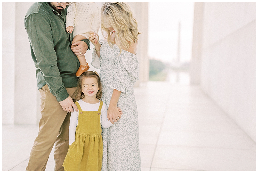 Little girl smiles during her family photos at the Lincoln Memorial