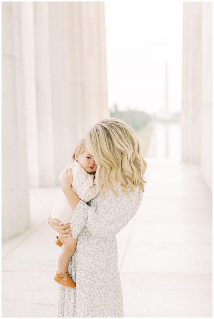 Mother holds her baby at the Lincoln Memorial during their DC photo session