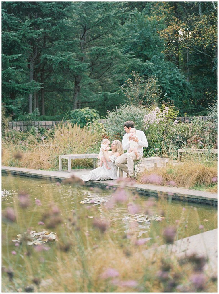 Parents holding their baby twin girls during their twin family session outside of Washington DC