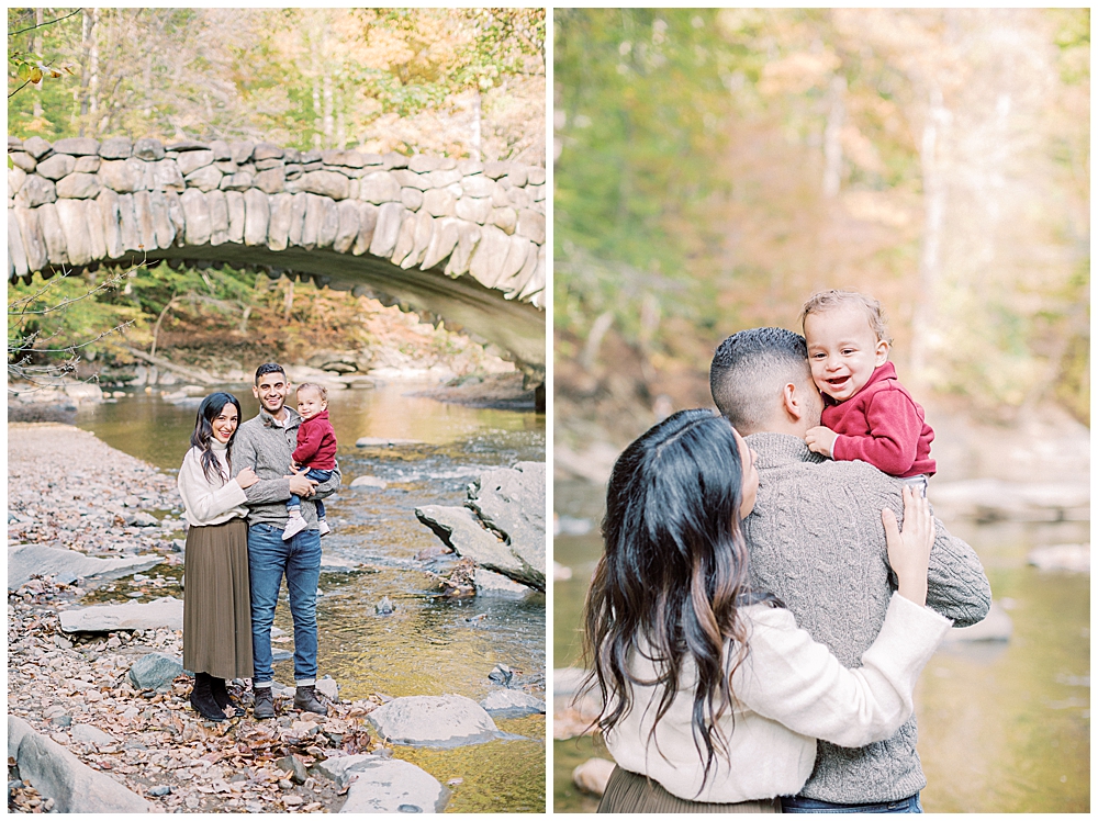 Mother, father, and baby boy take photos in front of Boulder Bridge in Rock Creek Park