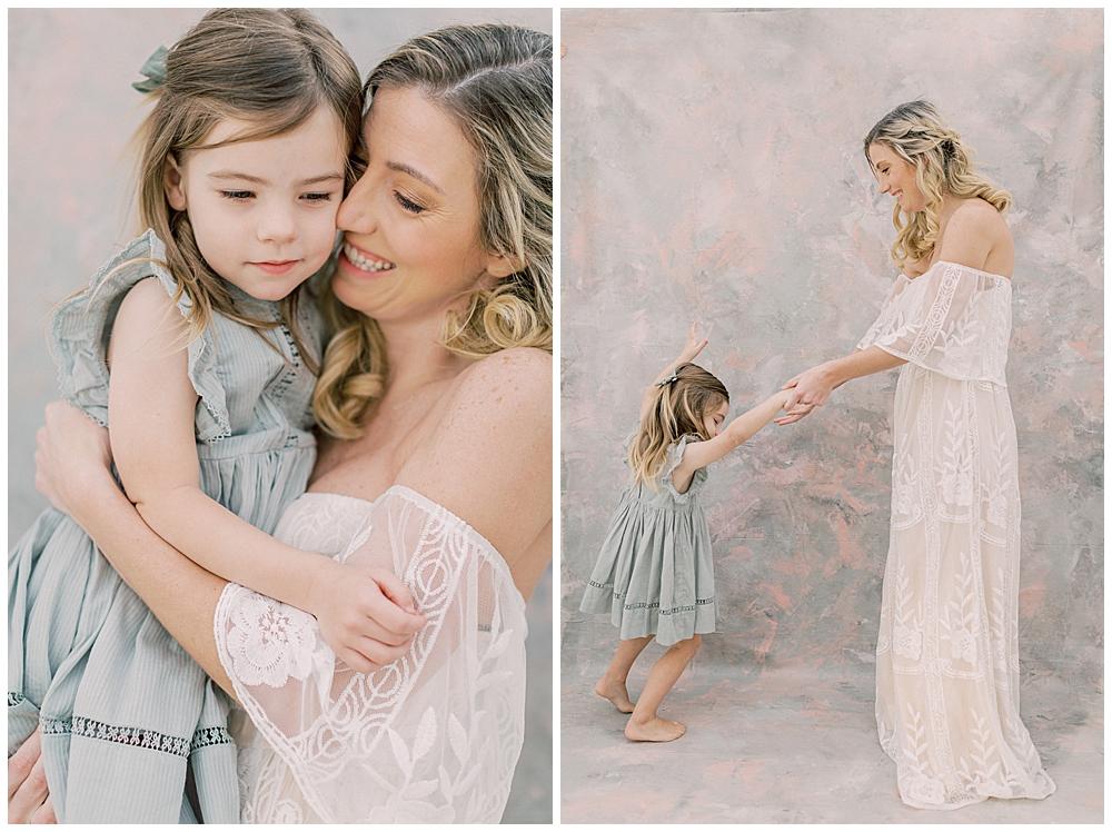 Mother and daughter dance together during their studio motherhood session