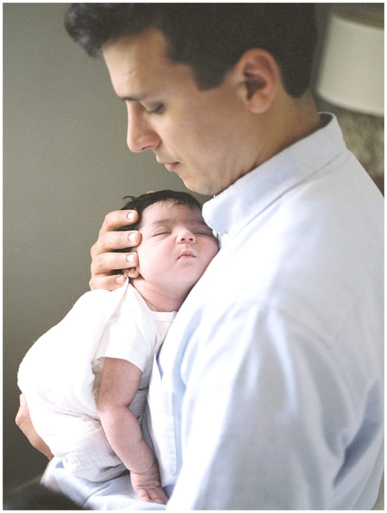 A father holds his infant daughter 