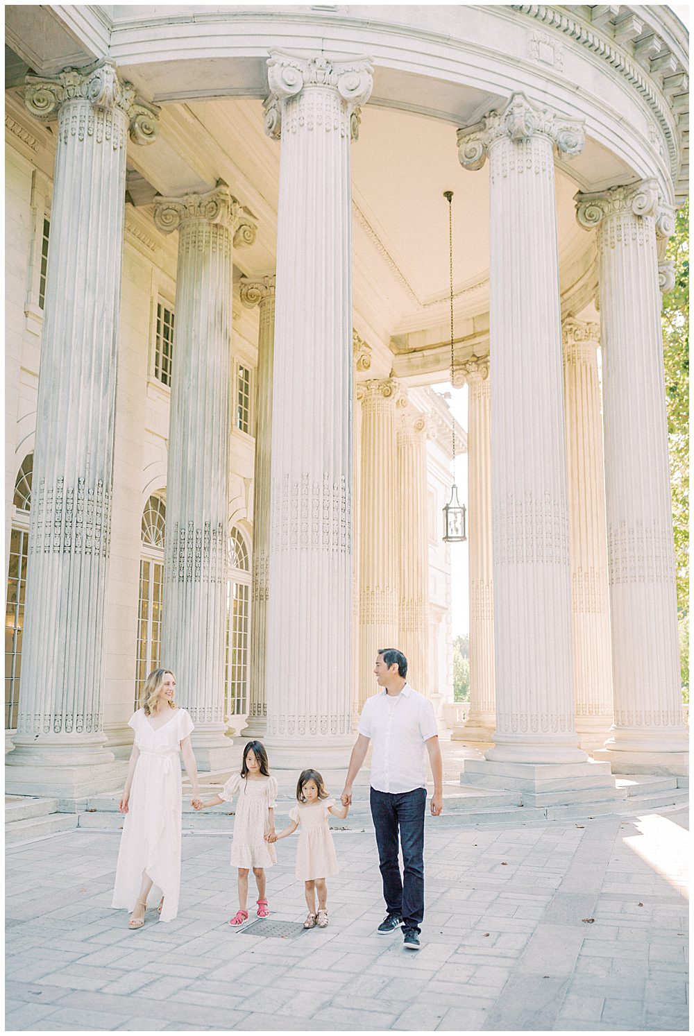 Family walks together in front of columns at DAR Constitution Hall.