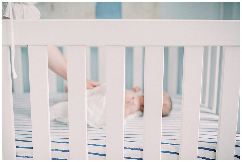 Baby boy lays in his crib