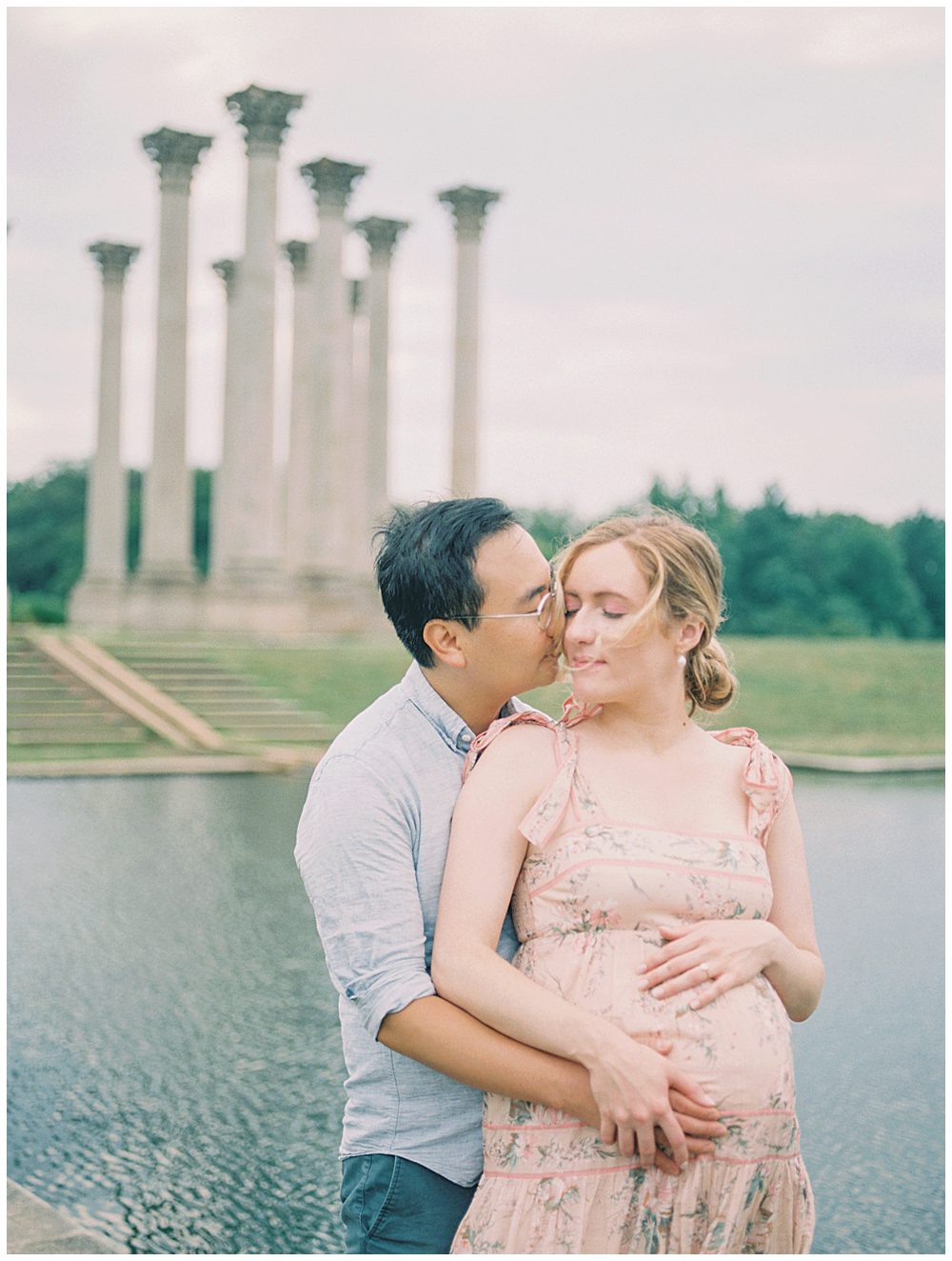 Husband leans into his wife's cheek during their National Arboretum maternity session.