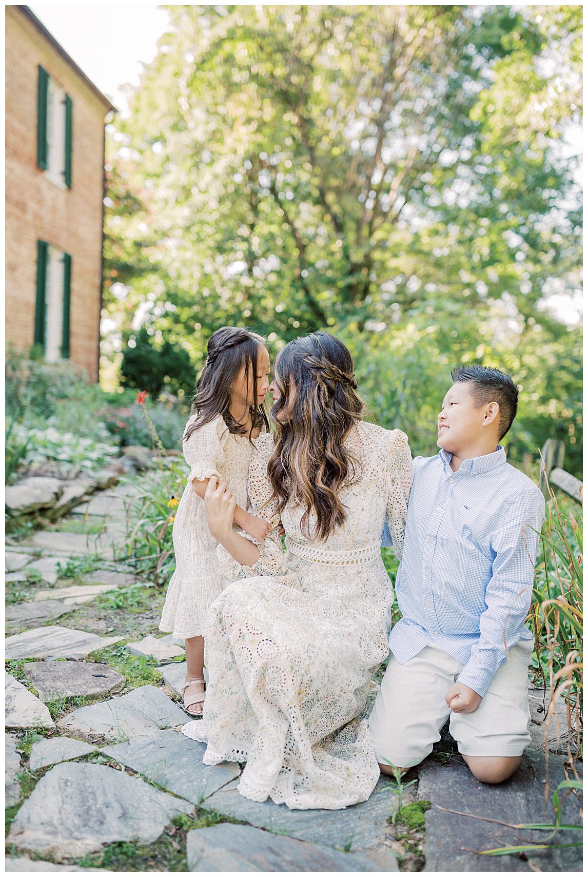 Mother kneels with her two children during her Colvin Run Mill Family Photos.